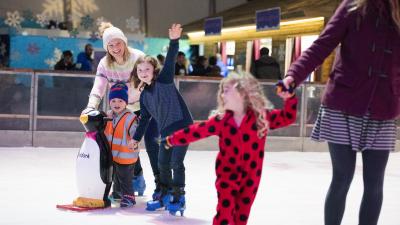 Children and parents ice skating at the Eden Project